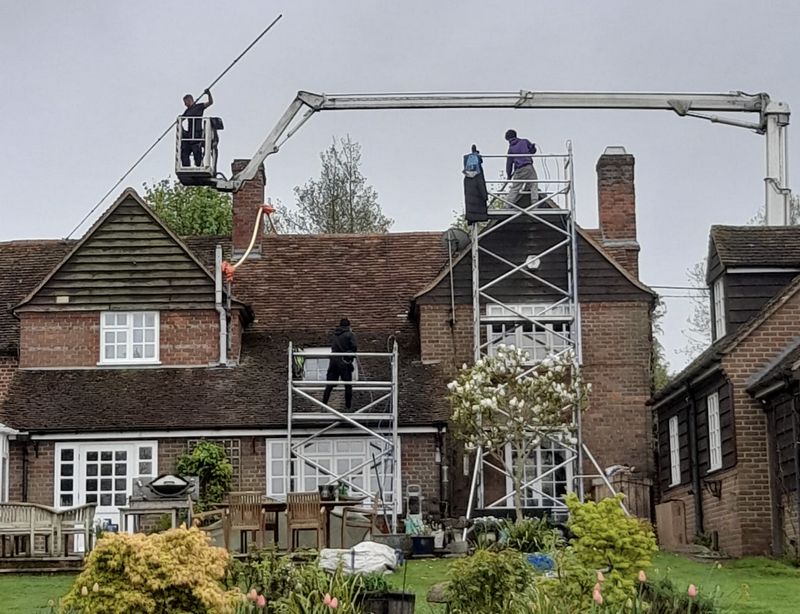 The Moss Cleaners using cherry picker and scaffolding to clean roof safely and professionally in 80 Walton Rd, Molesey, East Molesey KT8 0DP, UK, 80 Walton Rd, Molesey, East Molesey KT8 0DP, UK